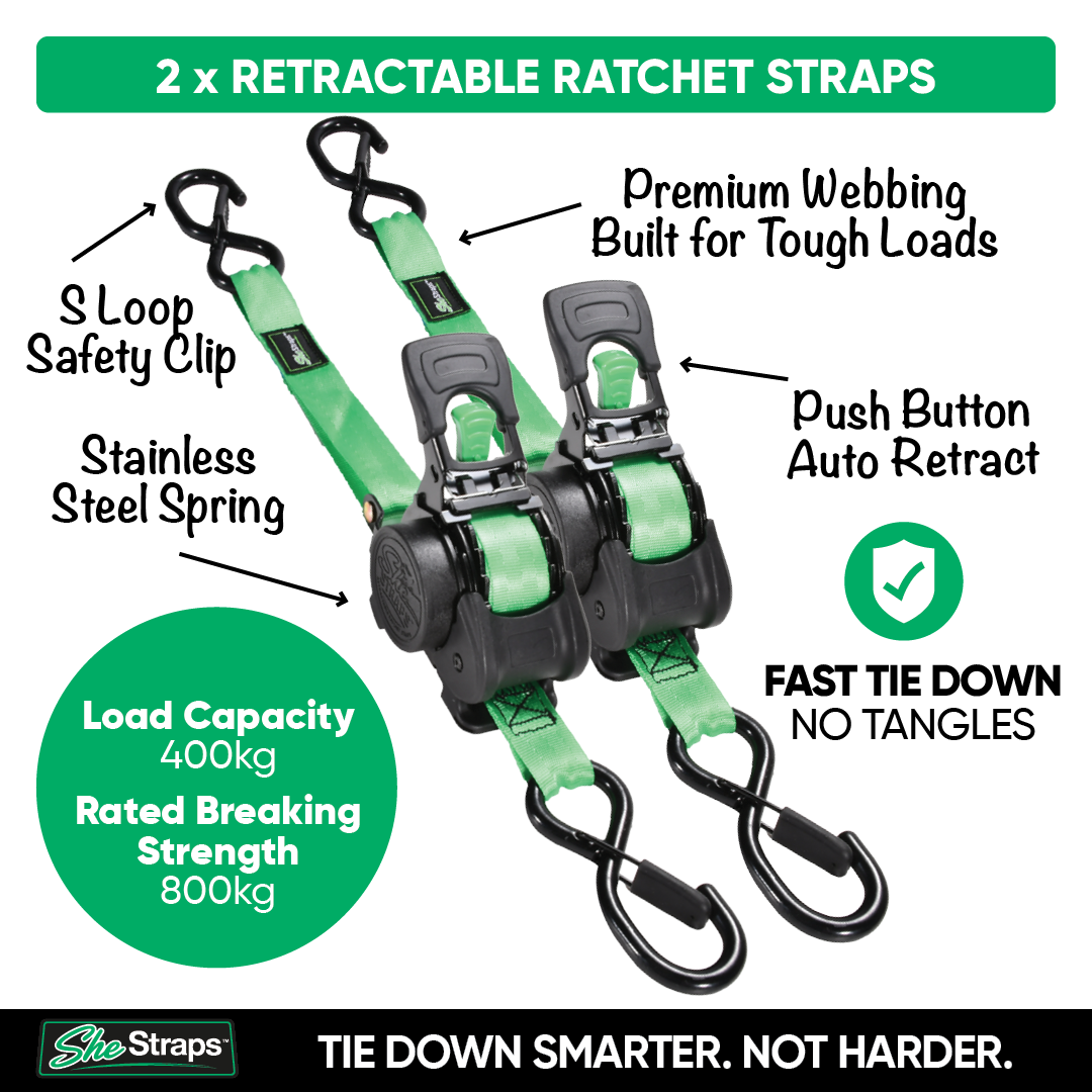 Two green and black retractable ratchet straps shown on a white background with callout labels, a green load capacity badge, and a SheStraps logo at the bottom.